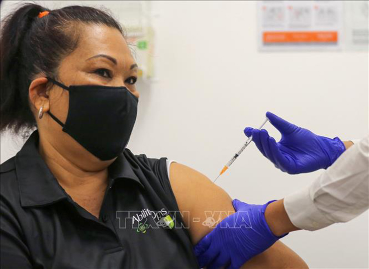 Người dân được tiêm vaccine phòng COVID-19 tại trung tâm y tế ở Sydney, Australia. Ảnh tư liệu: AFP/TTXVN