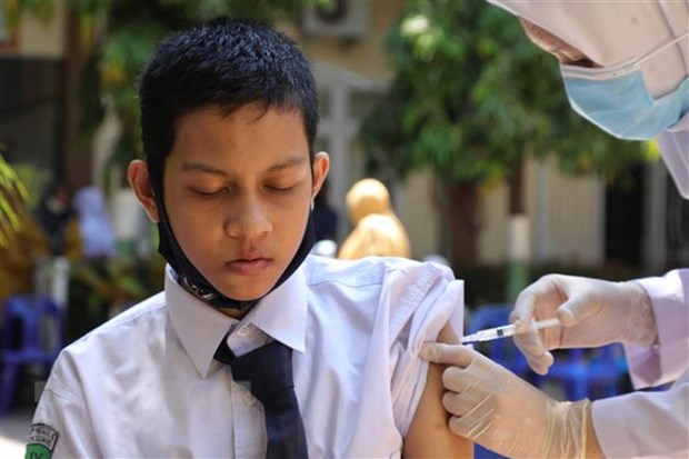 Nhân viên y tế tiêm vaccine ngừa COVID-19 cho học sinh tại tỉnh Aceh, Indonesia. (Ảnh: AFP/TTXVN)
