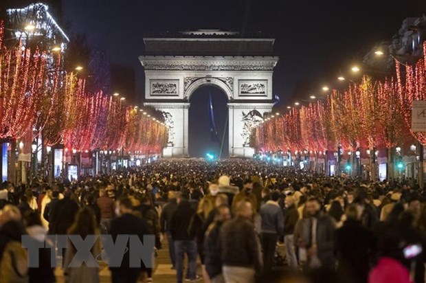 Người dân Paris tập trung tại Đại lộ Điện Elysees (Pháp) mừng Năm mới 2022, đêm 31-12-2021. (Ảnh: THX/TTXVN)