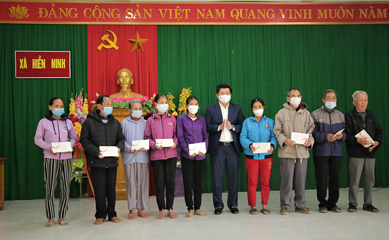 Đồng chí Trưởng ban Tổ chức Tỉnh ủy Trần Vũ Khiêm trao quà Tết cho các gia đình tại xã Hiền Ninh.