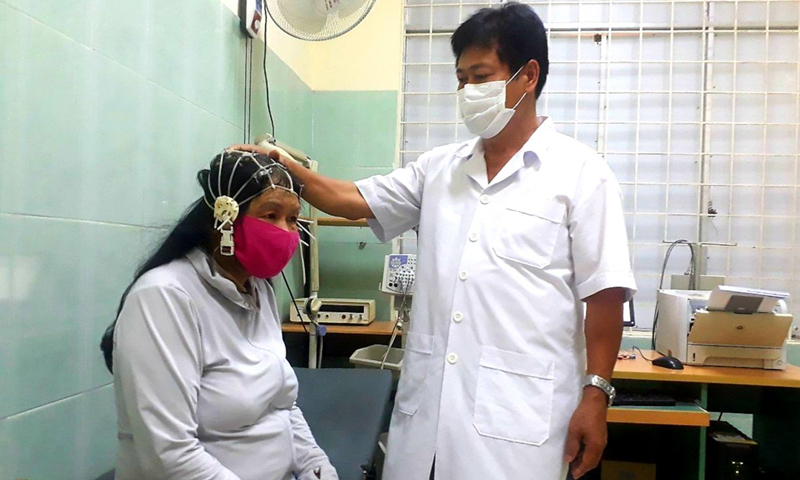 Bác sĩ Hồ Huy Hiệu đang thực hiện kỹ thuật đo điện não đồ cho bệnh nhân.