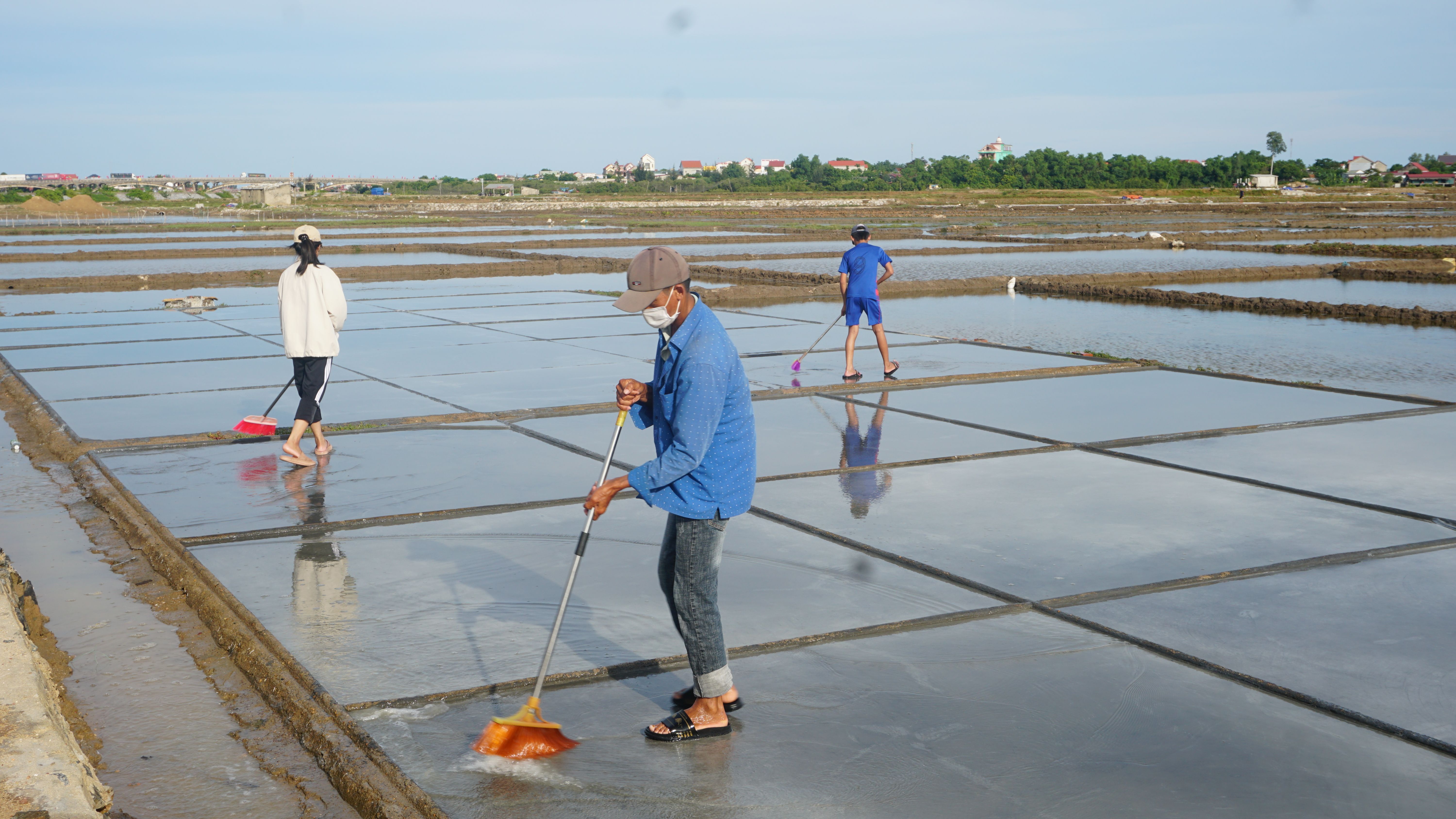 Sau cơn mưa, diêm dân Quảng Phú vệ sinh lại ruộng muối để sản xuất.