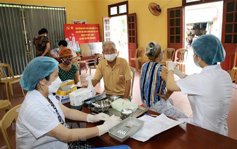 Nhân viên y tế tiêm vaccine ngừa COVID-19 cho người dân. (Ảnh: Nguyễn Chinh/TTXVN)