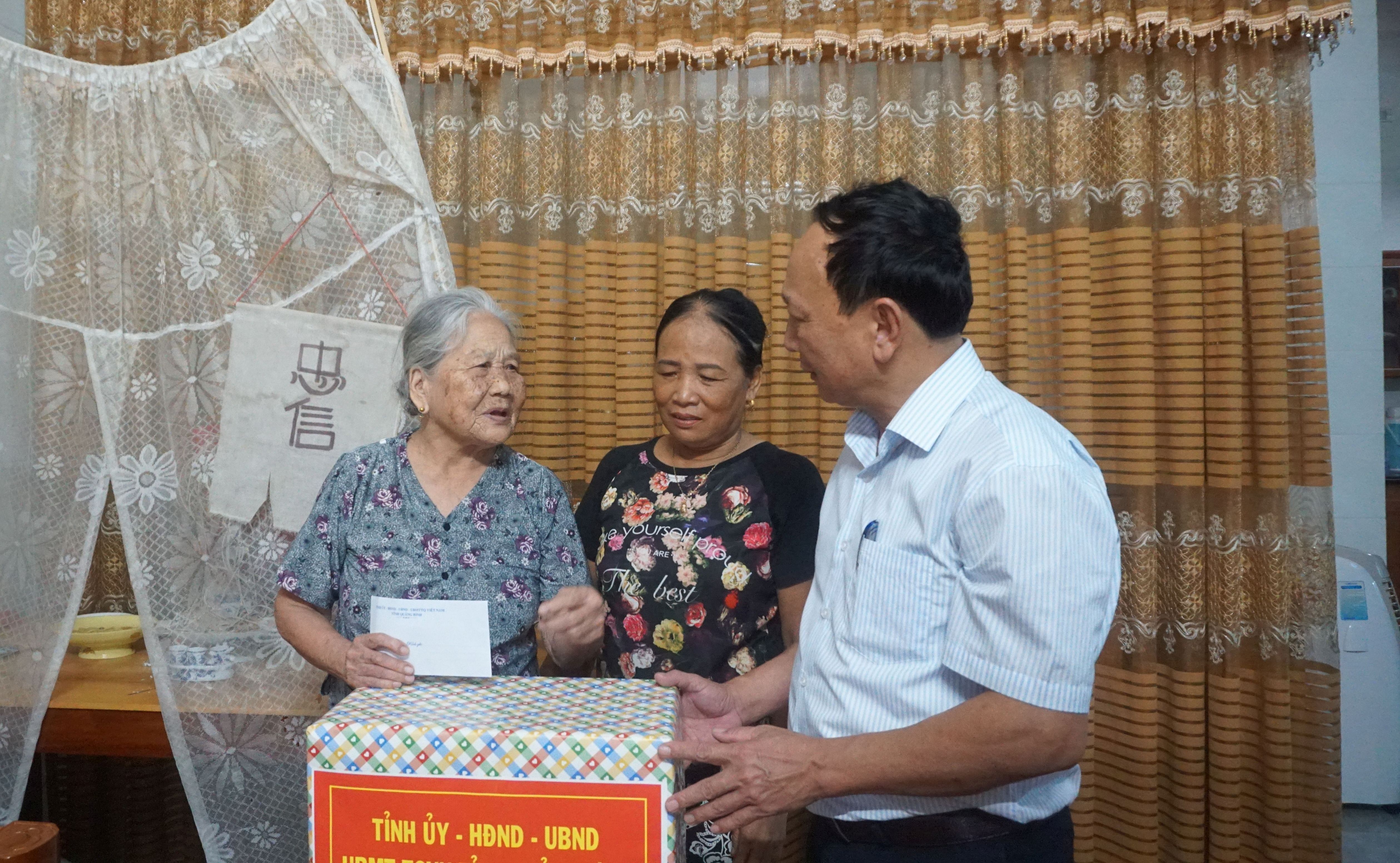 Đồng chí Phó Bí thư Thường trực Tỉnh ủy ân tặng quà cho Mẹ Việt Nam anh hùng Hoàng Thị Hy.