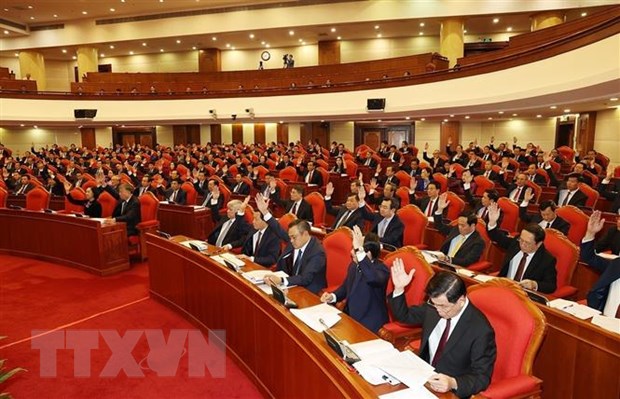 Các đồng chí lãnh đạo Đảng, Nhà nước và các đại biểu biểu quyết thông qua chương trình hội nghị trong ngày khai mạc. (Ảnh: Trí Dũng/TTXVN)