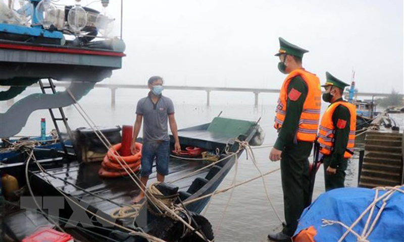 Cán bộ, chiến sĩ Đồn Biên phòng Vinh Hiền tuyên truyền pháp luật cho chủ tàu cá ở xã Vinh Hiền, huyện Phú Lộc, Thừa Thiên-Huế. (Ảnh: Đỗ Trưởng/TTXVN)