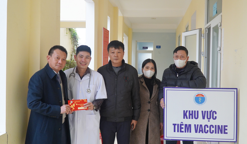 Giám đốc CDC Quang Bình bác sĩ Đỗ Quốc Tiệp tặng quà động viên cán bộ y tế trực tiêm chủng vắc xin phòng Covid-19 dịp Tết nguyên đán.