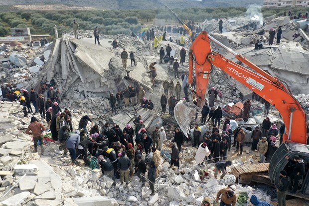 Lực lượng cứu hộ tìm kiếm nạn nhân trong đống đổ nát sau trận động đất tại Harim, tỉnh Idlib (Syria), giáp giới với Thổ Nhĩ Kỳ. (Ảnh: AFP/TTXVN)