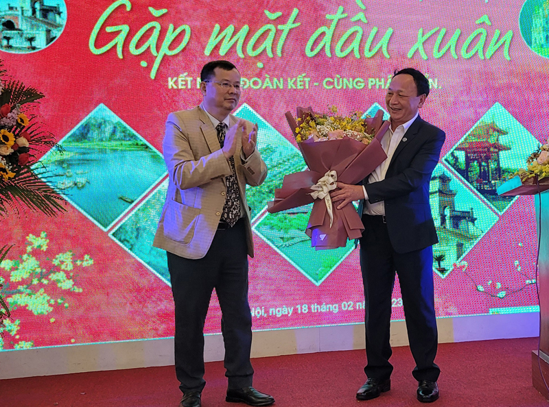 Ông Nguyễn Đức Tuấn, Chủ tịch Hội đồng Quảng Bình tại TP.Hà Nội tặng hoa chúc mừng đồng chí Trần Hải Châu