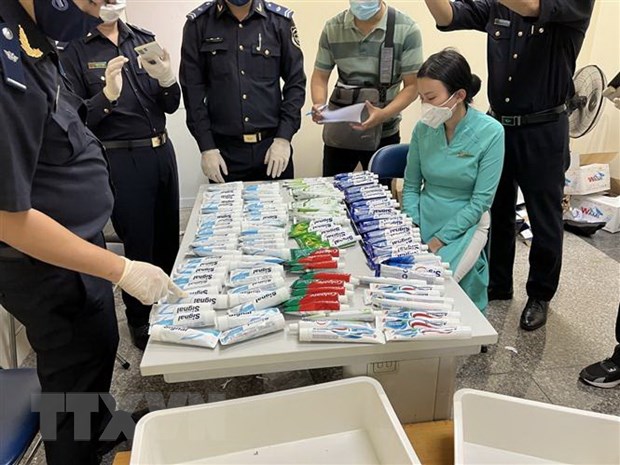 Kiểm đếm lô hàng chất ma túy được giấu trong những tuýp kem đánh răng bị thu giữ từ hành lý của 4 tiếp viên hàng không. (Ảnh: TTXVN phát)