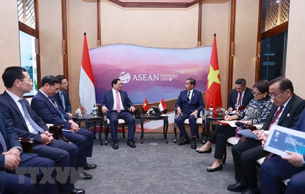  Thủ tướng Phạm Minh Chính gặp Tổng thống Indonesia Joko Widodo. (Ảnh: Dương Giang/TTXVN)