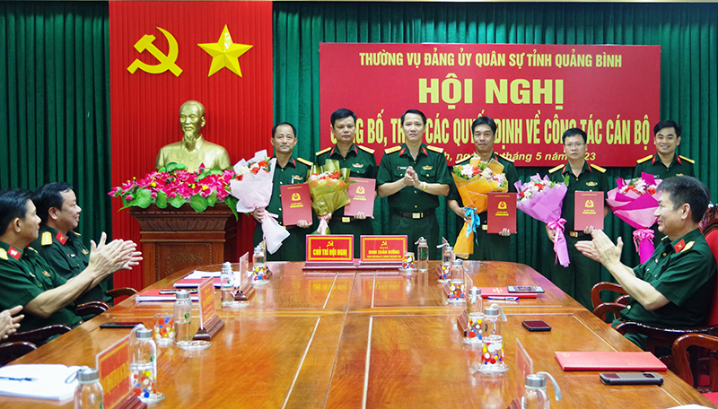 Đại tá Đinh Xuân Hướng, Phó bí thư Đảng ủy, Chính ủy Bộ CHQS tỉnh trao các quyết định công tác cán bộ và tặng hoa chúc mừng.
