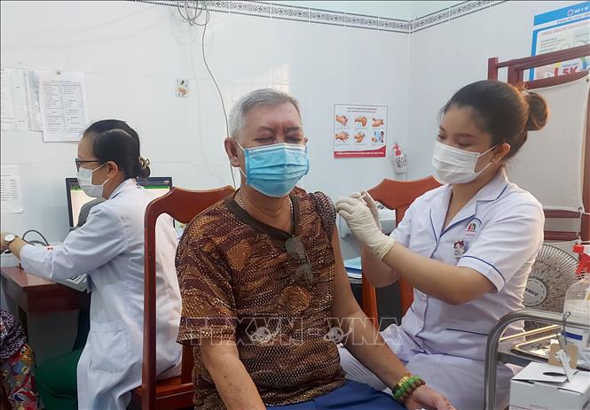 Tiêm vaccine phòng COVID-19 cho người già, người có nguy cơ cao. Ảnh: TTXVN