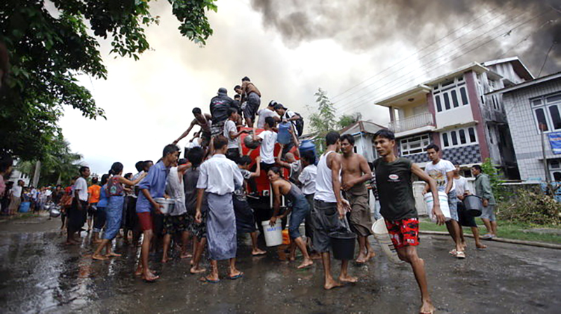 Người dân bang Rakhine tập trung chữa các đám cháy trong cuộc xung đột sắc tộc - Ảnh: Reuters