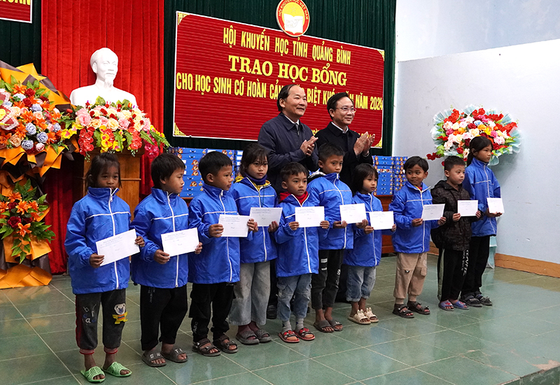 Đồng chí Phó Chủ tịch HĐND tỉnh Hoàng Xuân Tân và lãnh đạo Hội Khuyến học tỉnh trao học bổng cho các học sinh.