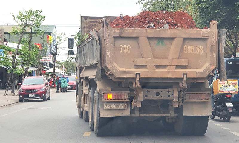 xe chở đất vượt quá chiều cao thành thùng xe và không che bạt theo quy định lưu thông trên tuyến đường Lê Lợi, phường Đức Ninh Đông.