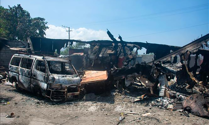 Các phương tiện bị đốt cháy trong bạo lực băng nhóm ở thủ đô Port-au-Prince, Haiti, ngày 25/3/2024. Ảnh: AFP/TTXVN