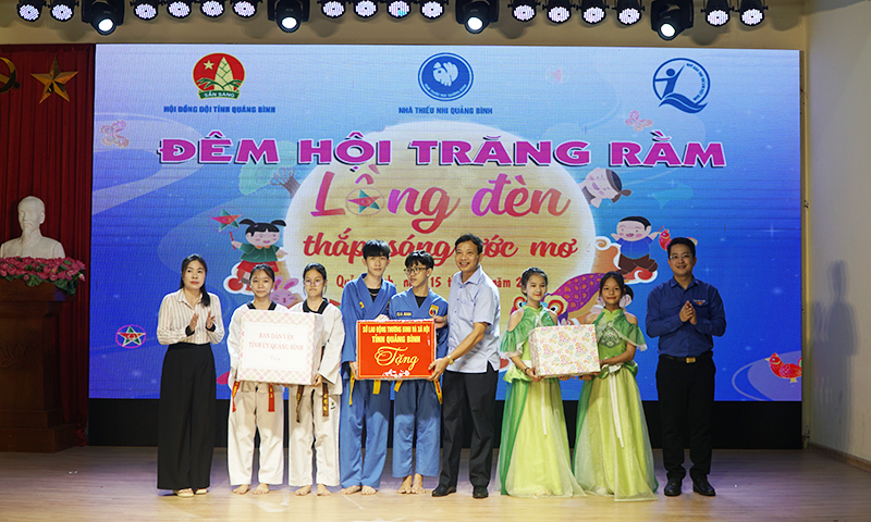Đại diện lãnh đạo Ban Dân vận Tỉnh uỷ, Sở Lao động,Thương binh và xã hội và Tỉnh đoàn tặng quà cho các em thiếu nhi.