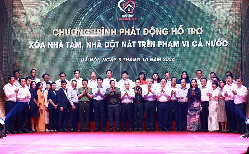 Thủ tướng Phạm Minh Chính với đại diện các tổ chức, doanh nghiệp hỗ trợ kinh phí xóa nhà tạm, nhà dột nát. (Ảnh: Dương Giang/TTXVN)