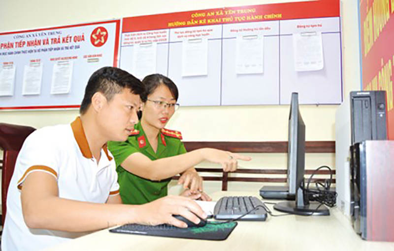 Cán bộ Công an xã hướng dẫn người dân giải quyết thủ tục hành chính trực tuyến trên Cổng Dịch vụ công quốc gia.