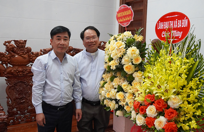 Đồng chí Chủ tịch Ủy ban MTTQVN tỉnh Phạm Quang Long tặng hoa, quà cho Giáo xứ Văn Phú.