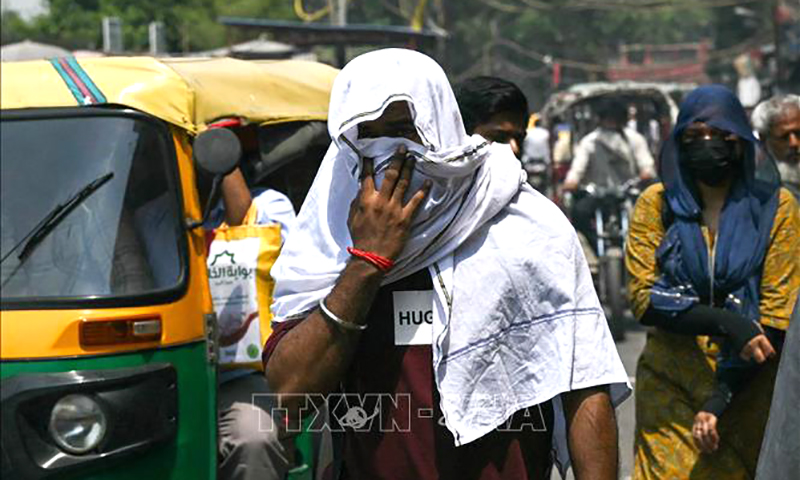 Người dân di chuyển dưới trời nắng nóng tại New Delhi, Ấn Độ ngày 22/5/2024. Ảnh tư liệu: AFP/TTXVN